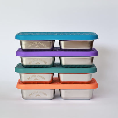 Set of stainless steel containers with colorful lids on a white background
